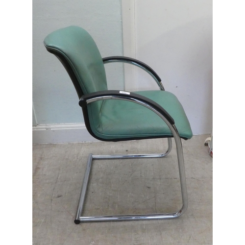 235 - A modern Verco desk chair with a cushioned green hide upholstered seat, on a splayed frame