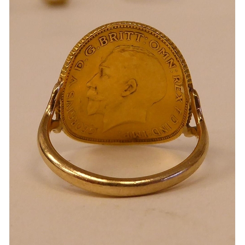 25 - A George V half-sovereign set, 9ct gold band ring