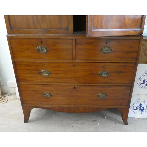 272 - An early Victorian mahogany linen press with a moulded cornice, over two panelled doors, enclosing t... 