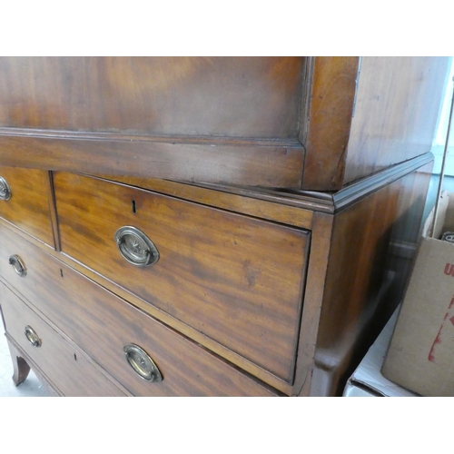 272 - An early Victorian mahogany linen press with a moulded cornice, over two panelled doors, enclosing t... 