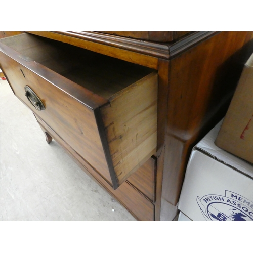 272 - An early Victorian mahogany linen press with a moulded cornice, over two panelled doors, enclosing t... 