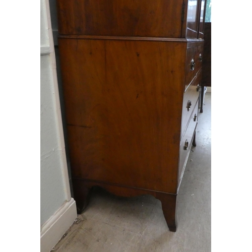 272 - An early Victorian mahogany linen press with a moulded cornice, over two panelled doors, enclosing t... 