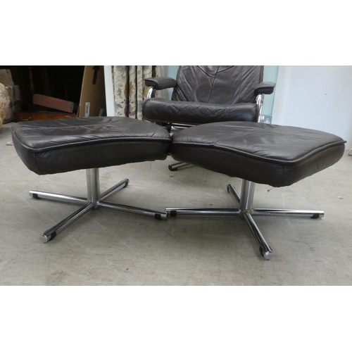 273 - A circa 1970s Norwegian Skoghaug Industries brown hide upholstered rotating arm chair, raised on a s... 