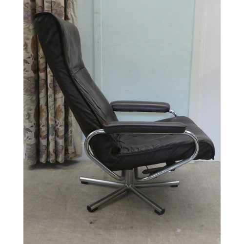 273 - A circa 1970s Norwegian Skoghaug Industries brown hide upholstered rotating arm chair, raised on a s... 