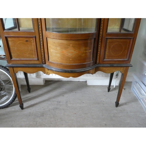 45 - An Edwardian string inlaid marquetry mahogany display cabinet, the central bow front section flanked... 