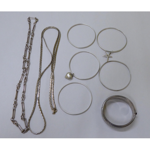 11 - Silver and white metal items of personal ornament: to include watch chains; bangles; and rings ... 