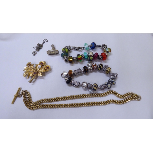 12 - Items of personal ornament: to include loose charms; and a gold plated pocket watch chain with T-bar