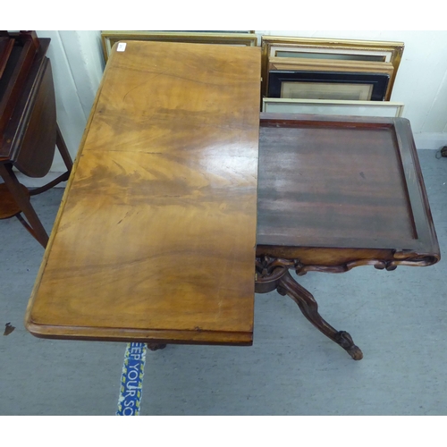 211 - A mid Victorian mahogany tea table, the rotating, foldover top over a bulbous column and carved quad... 