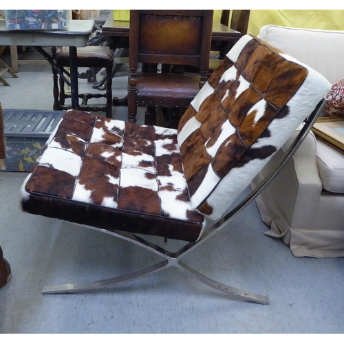 339 - A Barcelona style, chrome finished chair and stool, each with animal skin upholstered cushions