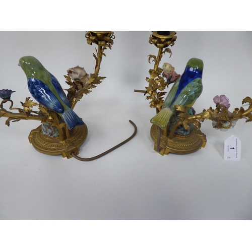 1 - A pair of table lights, each comprising two gilt metal and painted porcelain branches, separated by ... 