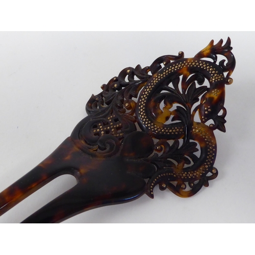 10 - A 19thC carved tortoiseshell mantilla comb, decorated with studs and a serpent; and a contemporary o... 