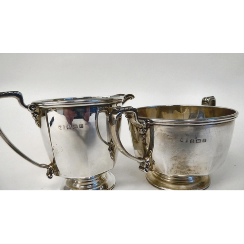 109 - A silver milk jug of panelled, octagonal form with a spout and handle, on a pedestal footrim; and a ... 