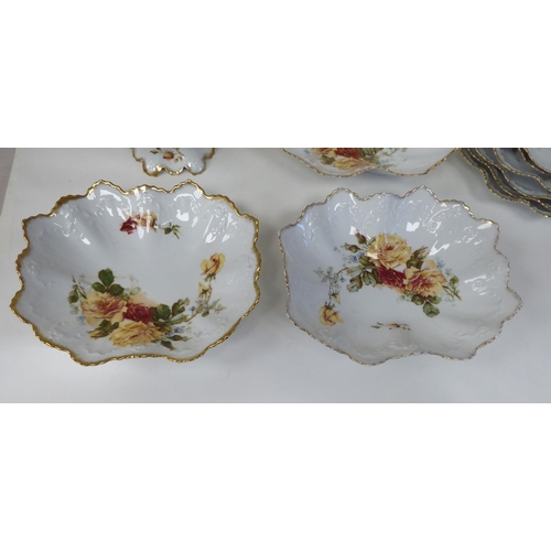 11 - An Austrian porcelain dessert service, decorated with trailing roses, comprising six frilled and gil... 