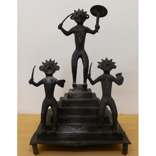 121 - A tribal blackened iron group, depicting three dancing figures, on a stepped base  13