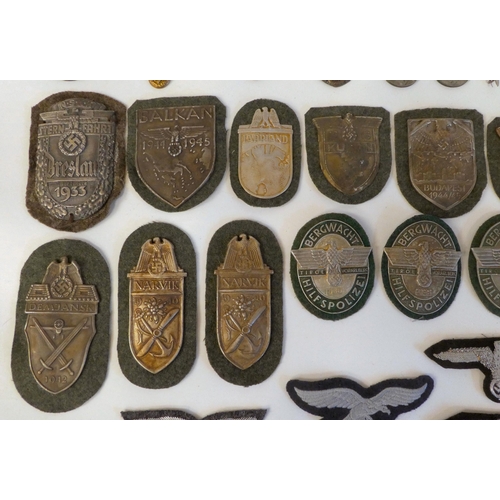 130 - A miscellany of German Nazi era badges: to include a Motorstaffel NSKK; and other embroidered unifor... 