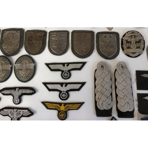 130 - A miscellany of German Nazi era badges: to include a Motorstaffel NSKK; and other embroidered unifor... 