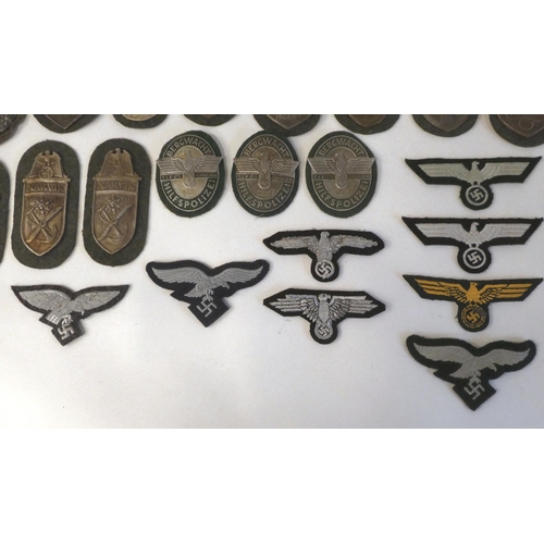 130 - A miscellany of German Nazi era badges: to include a Motorstaffel NSKK; and other embroidered unifor... 