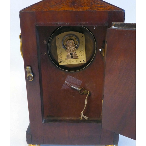 137 - A late Regency mahogany and inlaid brass cased mantel timepiece with a pointed arch top, straight si... 