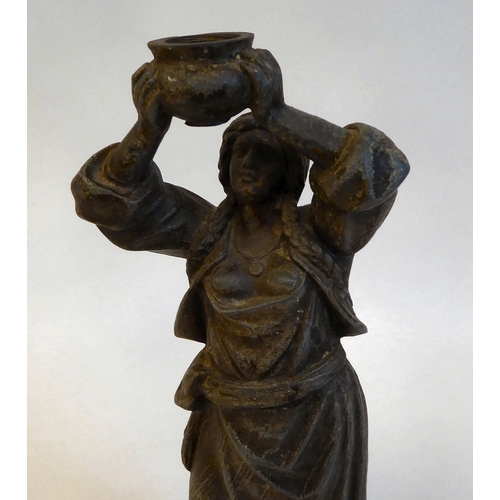 143 - A late 19thC spelter lamp base, a standing figure of a woman with plaits, holding aloft a bowl, on a... 