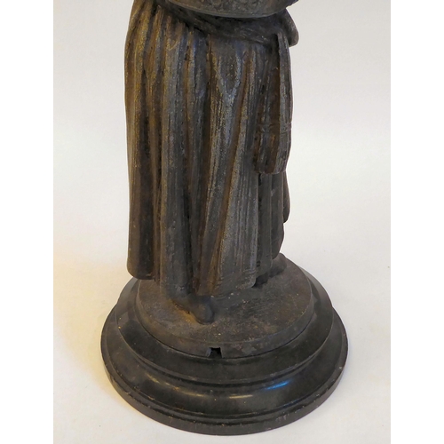 143 - A late 19thC spelter lamp base, a standing figure of a woman with plaits, holding aloft a bowl, on a... 