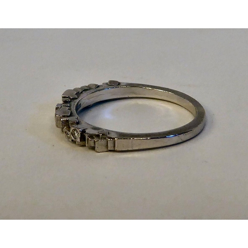 148 - An 18ct white gold ring, randomly set with six small diamonds