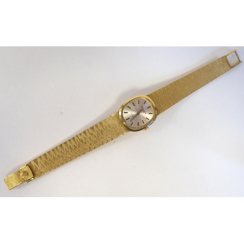 151 - A lady's Patek Phillipe 18ct gold cased bracelet wristwatch, faced by a silvered and gilded baton di... 