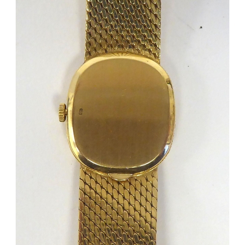 151 - A lady's Patek Phillipe 18ct gold cased bracelet wristwatch, faced by a silvered and gilded baton di... 