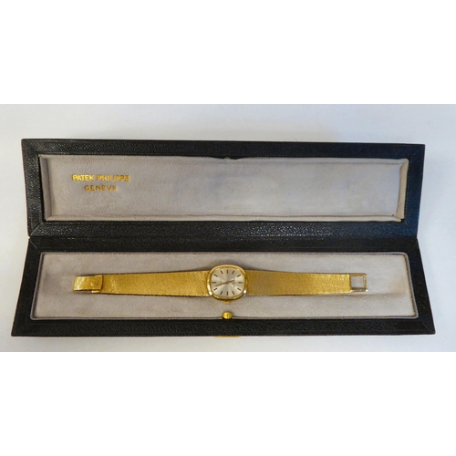 151 - A lady's Patek Phillipe 18ct gold cased bracelet wristwatch, faced by a silvered and gilded baton di... 