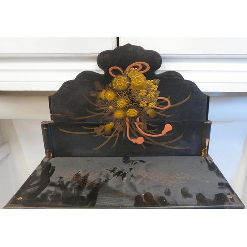 153 - An early 20thC Japanese black lacquered and gilded table cabinet, traditionally decorated in chinois... 