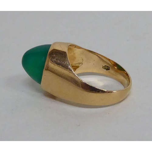 155 - An 18ct gold ring, set with a cabochon cut green stone