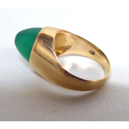 155 - An 18ct gold ring, set with a cabochon cut green stone