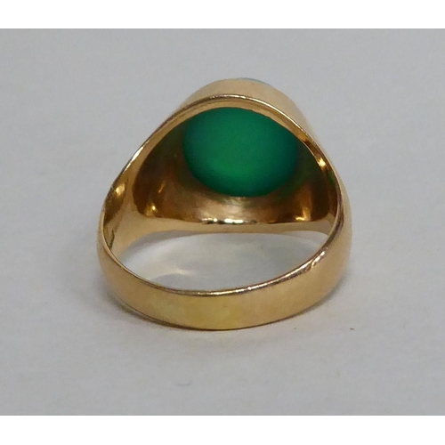 155 - An 18ct gold ring, set with a cabochon cut green stone