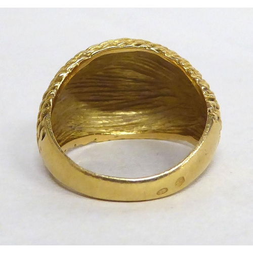 179 - A yellow metal textured signet ring