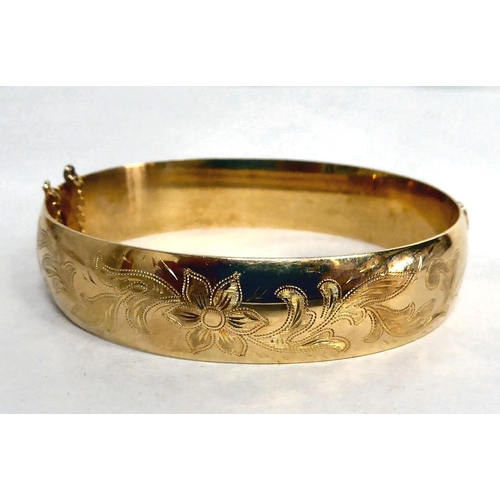 183 - A yellow metal bangle  bearing indistinct marks