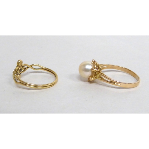 192 - Two yellow metal rings, one set with a pearl; the other a sapphire and diamonds