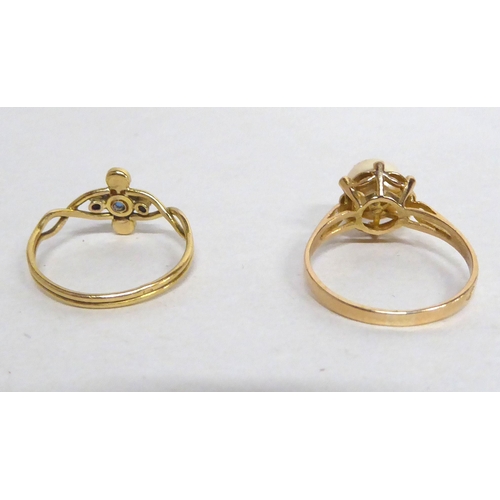 192 - Two yellow metal rings, one set with a pearl; the other a sapphire and diamonds