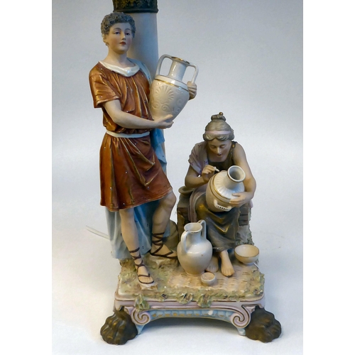 196 - A 20thC Royal Dux ceramic table lamp, fashioned as a Biblical group, depicting a young man and woman... 