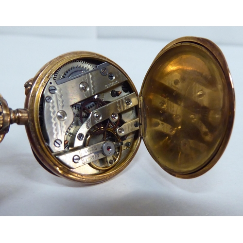 219 - An early 20thC lady's yellow metal cased fobwatch, faced by an enamelled Roman dial, on a fine curb ... 