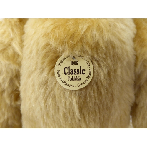 22 - A Steiff Classic 1906 mohair covered Teddy bear with a mobile head, limbs, a stitched nose and a gro... 