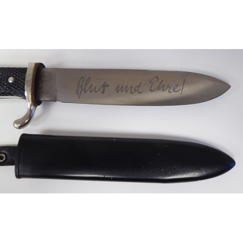 222 - A Hitler Youth knife with a textured two-part handgrip and an enamelled emblem, the RZM blade with a... 