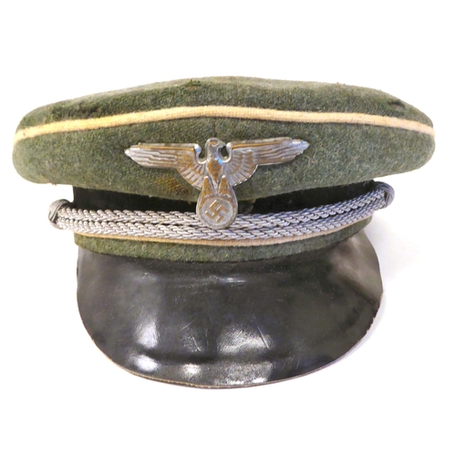 243 - A German SS green and black peaked cap with white piping, emblems and a silvered cord(Please Note: t... 