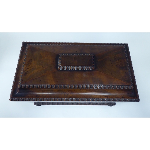 25 - A William IV figured mahogany tea casket of sarcophagus form with bead and reel carved borders, on b... 