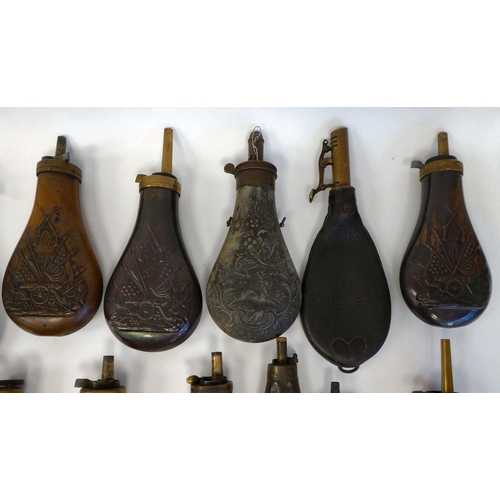 251 - Approximately twenty-five powder/shot flasks of traditional design with brass nozzles, variously mad... 