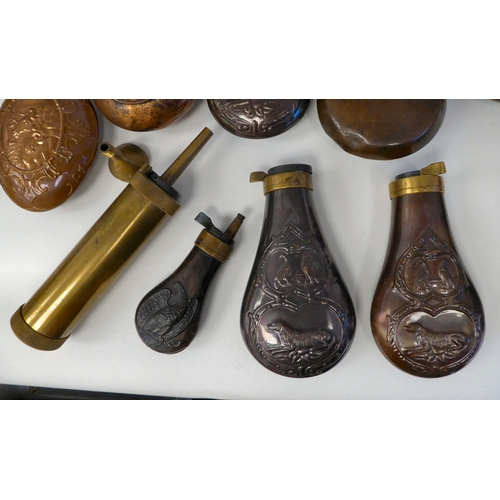 251 - Approximately twenty-five powder/shot flasks of traditional design with brass nozzles, variously mad... 