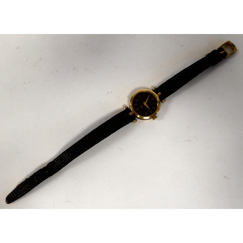 278 - A lady's Gucci gilded and black cased wristwatch, faced by a black Roman dial, on a dedicated black ... 