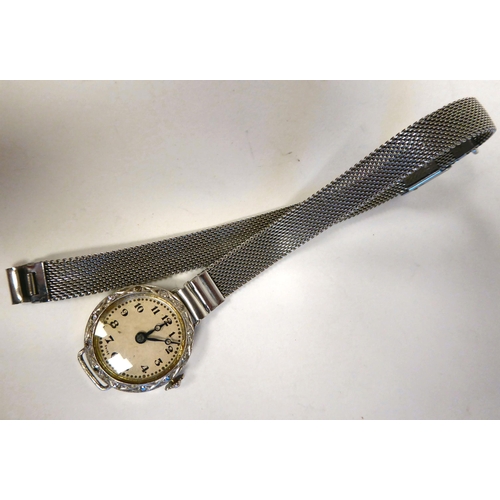 282 - A lady's 14ct white gold wristwatch, the bezel set with small diamonds, faced by an Arabic dial, on ... 