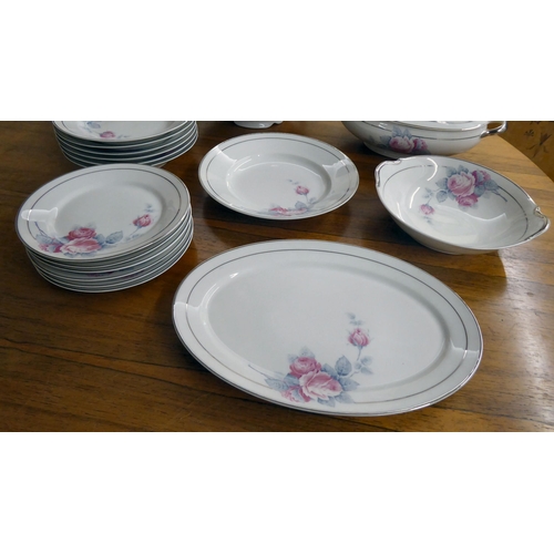 291 - A Limoges porcelain dinner service, decorated with pink roses and silver line trim