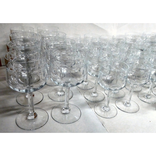 299 - A suite of Art Deco inspired crystal drinking glasses, each with line and circle cut ornament