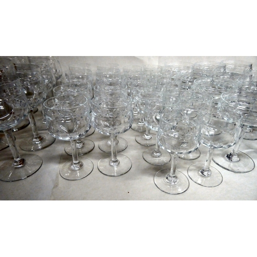 299 - A suite of Art Deco inspired crystal drinking glasses, each with line and circle cut ornament