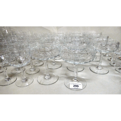 299 - A suite of Art Deco inspired crystal drinking glasses, each with line and circle cut ornament